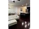 Open-concept living area with dark wood floors, neutral walls, a modern chandelier, and a kitchen island at 4858 Stratford Ln, Johns Creek, GA 30022