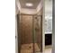 Shower with tiled walls, a glass door, and a built-in shelf at 4858 Stratford Ln, Johns Creek, GA 30022