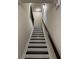 Carpeted staircase with dark wood railing and white trim at 4858 Stratford Ln, Johns Creek, GA 30022