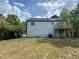 View of the home's backyard with a wood deck and mature trees at 1185 Jocelyn Ct, Stone Mountain, GA 30088