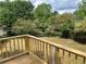 Backyard with wooden deck surrounded by lush trees and green space at 1185 Jocelyn Ct, Stone Mountain, GA 30088