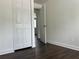 A bedroom featuring a closet and dark brown floors at 1185 Jocelyn Ct, Stone Mountain, GA 30088