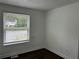 An efficiently designed bedroom with a street view from the window at 1185 Jocelyn Ct, Stone Mountain, GA 30088