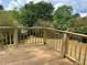 View of the home's wood deck with wood railings at 1185 Jocelyn Ct, Stone Mountain, GA 30088