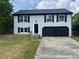 Charming two-story home with blue siding, black shutters and a spacious two-car garage at 1185 Jocelyn Ct, Stone Mountain, GA 30088