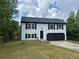 Charming two-story home with blue siding, black shutters and a spacious two-car garage at 1185 Jocelyn Ct, Stone Mountain, GA 30088