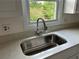 Close up of the kitchen sink and stone countertops at 1185 Jocelyn Ct, Stone Mountain, GA 30088