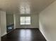 Spacious living room with wood floors, white walls and a large window at 1185 Jocelyn Ct, Stone Mountain, GA 30088