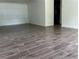 Bright living room featuring wood-look tile flooring and white walls at 1185 Jocelyn Ct, Stone Mountain, GA 30088