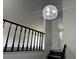 A staircase with a dark wood floor and decorative lighting at 1185 Jocelyn Ct, Stone Mountain, GA 30088