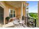 View of a well staged Balcony with a wrought iron table and seating overlooking a natural setting and the Chattahoochee river at 200 River Vista Dr # 540, Atlanta, GA 30339