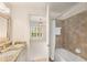 Bright bathroom with a granite countertop, a mirror and a combination tub and shower at 200 River Vista Dr # 540, Atlanta, GA 30339