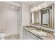 Elegant bathroom featuring a large mirror, granite countertop, and modern fixtures at 200 River Vista Dr # 540, Atlanta, GA 30339