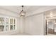 Well-lit bedroom with plantation shutters and modern light fixture, leading to other rooms at 200 River Vista Dr # 540, Atlanta, GA 30339