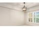 Bright bedroom featuring plantation shutters and a modern light fixture at 200 River Vista Dr # 540, Atlanta, GA 30339