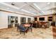An inviting common area with stone floors, a round table, TV screens, and coffered ceilings at 200 River Vista Dr # 540, Atlanta, GA 30339