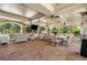 A covered patio with brick flooring and ample seating for residents to relax and socialize at 200 River Vista Dr # 540, Atlanta, GA 30339