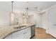 Well-appointed kitchen with granite countertops, modern lighting and stainless steel appliances at 200 River Vista Dr # 540, Atlanta, GA 30339