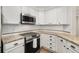 Stylish kitchen featuring stainless steel appliances, granite countertops, and white cabinetry at 200 River Vista Dr # 540, Atlanta, GA 30339