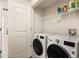Functional laundry room with modern, front-load washer and dryer set and shelving at 200 River Vista Dr # 540, Atlanta, GA 30339