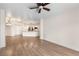 Open-concept living room with wood floors, and a view into the kitchen at 200 River Vista Dr # 540, Atlanta, GA 30339