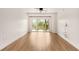 Bright living room with hardwood floors and a sliding glass door to the outdoor balcony at 200 River Vista Dr # 540, Atlanta, GA 30339
