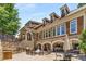 Community outdoor patio with stone features, including a fireplace, grill, and seating areas at 200 River Vista Dr # 540, Atlanta, GA 30339