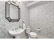 Stylish powder room with unique wallpaper, a modern mirror, and a pedestal sink at 200 River Vista Dr # 540, Atlanta, GA 30339