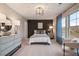 Well-lit bedroom featuring decorative accent wall and plush carpet at 290 Abbotts Crossing Cir, Conyers, GA 30094