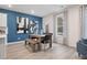 Bright dining room with hardwood floors, modern art, and a cozy window seat at 290 Abbotts Crossing Cir, Conyers, GA 30094