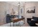 Stylish home office with a glass-top desk, comfortable seating, and decorative wallpaper at 290 Abbotts Crossing Cir, Conyers, GA 30094