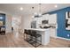 Bright open concept kitchen with a center island, stainless appliances, and access to the home's entryway at 290 Abbotts Crossing Cir, Conyers, GA 30094