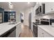Well-equipped kitchen featuring stainless appliances, modern lighting, and a spacious island for meal preparation at 290 Abbotts Crossing Cir, Conyers, GA 30094