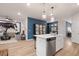Open concept kitchen boasts island seating, stainless appliances, and seamlessly flows into the inviting living space at 290 Abbotts Crossing Cir, Conyers, GA 30094