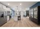 Open concept kitchen with stainless steel appliances, white cabinetry, and a view into the cozy living space at 290 Abbotts Crossing Cir, Conyers, GA 30094