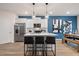 Modern kitchen with stainless steel appliances, sleek white cabinetry, and a center island with bar stool seating at 290 Abbotts Crossing Cir, Conyers, GA 30094