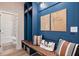 Inviting mudroom with wooden bench, storage, and convenient access to a full bathroom at 290 Abbotts Crossing Cir, Conyers, GA 30094