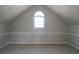 Finished attic space with neutral colors, chair rail and arched window at 5029 Preservation Pointe, Kennesaw, GA 30152