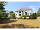 Lush backyard featuring mature trees, landscaping, and a well-manicured lawn surrounds the two-story home at 5029 Preservation Pointe, Kennesaw, GA 30152