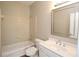 Bathroom with tile shower/tub, matching vanity, framed mirror, and toilet at 5029 Preservation Pointe, Kennesaw, GA 30152