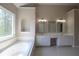 Primary bathroom with tub, dual sinks, mirrors, and vanity at 5029 Preservation Pointe, Kennesaw, GA 30152