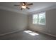 Neutral bedroom with a ceiling fan, trim detail, natural light, and neutral carpet at 5029 Preservation Pointe, Kennesaw, GA 30152