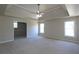 Large bedroom with a tray ceiling, ceiling fan, and two windows at 5029 Preservation Pointe, Kennesaw, GA 30152