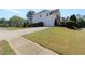 Charming two-story home with an attached garage, mature trees, and lawn at 5029 Preservation Pointe, Kennesaw, GA 30152