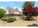 Charming brick home with manicured landscaping and mature trees on a sunny day at 5029 Preservation Pointe, Kennesaw, GA 30152
