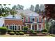 Elegant brick home featuring a charming front porch and well-maintained landscaping for a classic look at 5029 Preservation Pointe, Kennesaw, GA 30152