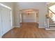 Spacious foyer with hardwood floors, a chandelier, and access to a dining area and staircase, showcasing elegance at 5029 Preservation Pointe, Kennesaw, GA 30152