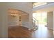 Open-concept foyer with hardwood floors, chandelier, and a staircase to the second level, offering a seamless flow at 5029 Preservation Pointe, Kennesaw, GA 30152