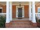 Elegant front entrance with a classic dark wood door, sidelights, and brick steps, providing a warm welcome at 5029 Preservation Pointe, Kennesaw, GA 30152