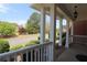 Spacious front porch with white railings and a charming overhead light fixture for welcoming guests at 5029 Preservation Pointe, Kennesaw, GA 30152